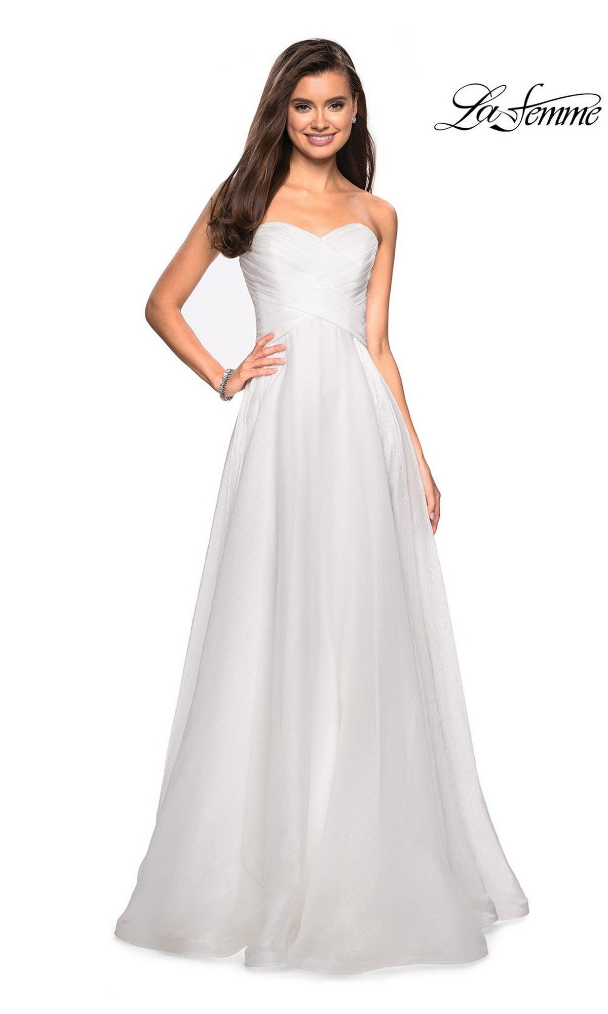 A woman models the La Femme Strapless Long Prom Ball Gown 27515, featuring a sweetheart bodice, flowing skirt, and elegant A-line silhouette. The La Femme logo appears in the top right corner.
